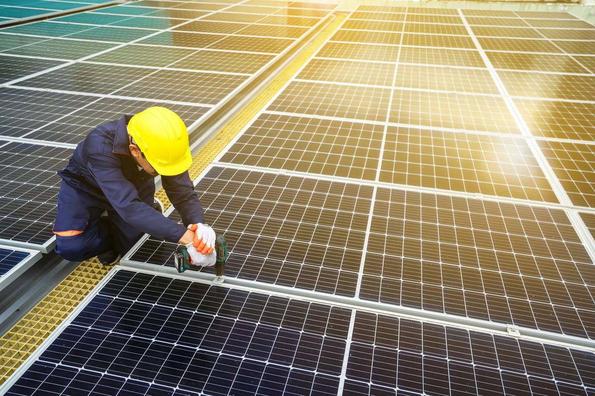 how to replace solar panel technician using insulated tools to disconnect MC4 connectors on a residential rooftop array